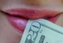 woman's mouth with $20 bill