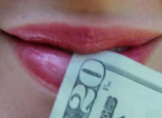 woman's mouth with $20 bill