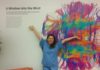 Susanna Zaraysky in scrubs in front of painting of the brain